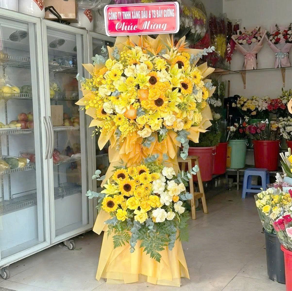 Kệ Hoa Mừng Khai Trương 2 Tầng Tone V&agrave;ng Cam Hướng Dương Mix Hoa Ly