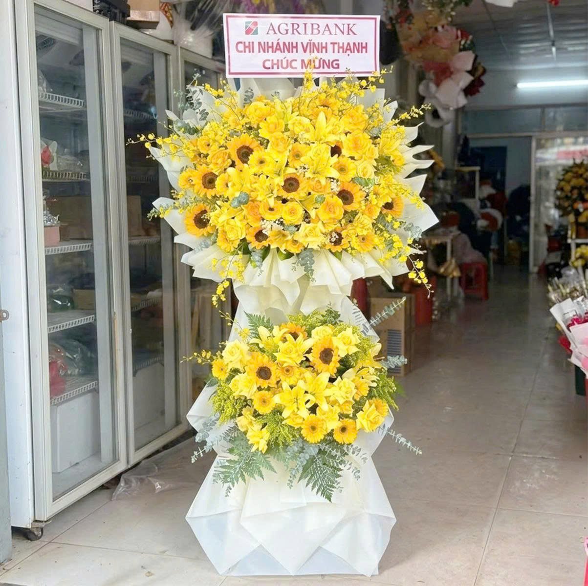 Kệ Hoa Mừng Khai Trương 2 Tầng Tone V&agrave;ng Hướng Dương Mix Hoa Ly